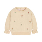 A cream-colored baby sweater with small embroidered flowers in pink, orange, and green scattered across the front, featuring ruffled cuffs and a ribbed crew neck, hem, and cuffs.