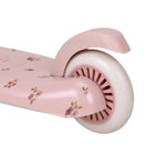 Pink scooter with floral design on a white background